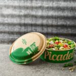 Graphic Packaging International and Picadeli partner to develop plastic-free fiber-based snap-closing lid puzzle for paper-based salad bowls. Bio-based, food and drink packaging, food and drink sustainable packaging, Food packaging Food and Beverage Business