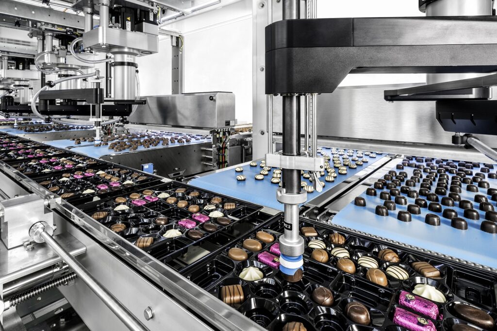 Fabulous trays Food and Beverage Business Fabulous trays 2D scanner quality control pralines, automated food packaging solutions Germany, automated praline packaging line, confectionery packaging line efficiency, flexible robot tool changing confectionery, high-speed chocolate packaging Poland, machine vision system chocolate inspection, precision pick and place chocolate trays, Schubert robotic tray loading, Toms praline production automation Food and Beverage Business automated praline packaging line,Schubert robotic tray loading,high-speed chocolate packaging Poland,2D scanner quality control pralines,flexible robot tool changing confectionery,precision pick and place chocolate trays,confectionery packaging line efficiency,Toms praline production automation,machine vision system chocolate inspection,automated food packaging solutions Germany