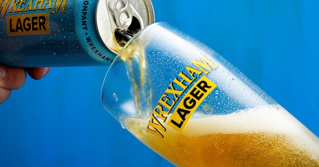 Wrexham Lager Debuts in Canada Food and Beverage Business Wrexham Lager Debuts in Canada 20-24 years, artisan, baker, bakery, Bread, Canada, caucasian, color image, England, Europe, European, fresh, head and shoulders, healthy eating, holding, horizontal, indoors, Lager, large group of objects, launches, loaf, London, Merchandise, one person, one young woman only, people, photography, quality, Reaching, rear view, retail, shelf, small business, Stocking, United kingdom, Woman, working, Wrexham, young adult Food and Beverage Business