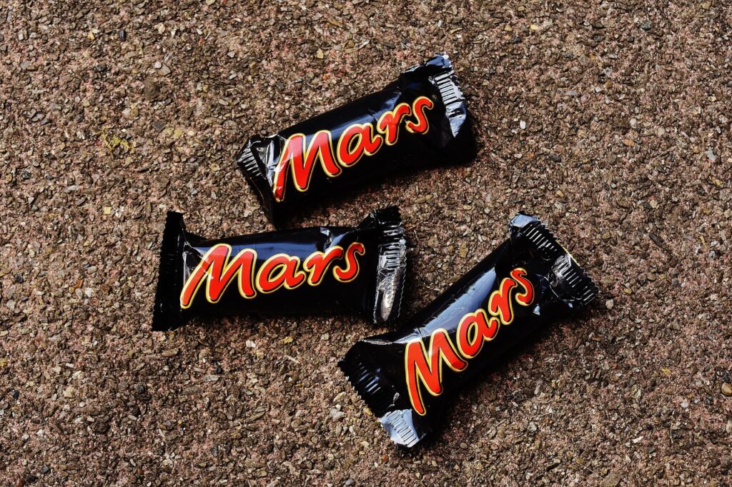 Mars Collaborates with Pairwise to Utilize CRISPR for Climate-Resilient Cocoa Production bounty candy bar, Candy, chocolate, chocolate candy, dove candy bar, food, heap, holding, human finger, human hand, Maltesers, mars bar, Mars incorporated, Milk Chocolate, milky way candy bar, no people, Small, Snack, snickers bar, sweet food, teasers, Twix, Women Food and Beverage Business
