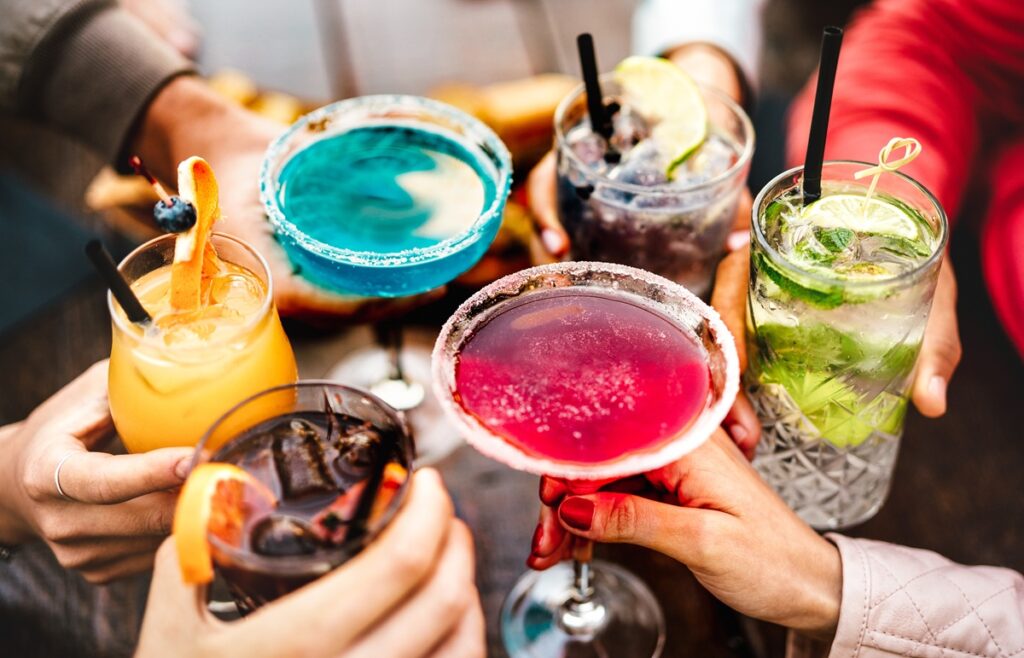 Colourful cocktails in group celebration - Dry by Design: How No/Low Alcohol Is Reshaping Production, Packaging and Profitability