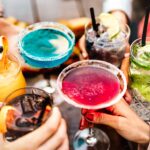 Colourful cocktails in group celebration - Dry by Design: How No/Low Alcohol Is Reshaping Production, Packaging and Profitability
