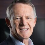 2 Sisters Appoints Former Defra Board Member to Lead Its Net Zero Strategy. blurred background, brown hen, chicken, clear foreground, Coop, domestic, egg-laying, farm animals, farming, feathered, red comb, rural, wattle Food and Beverage Business