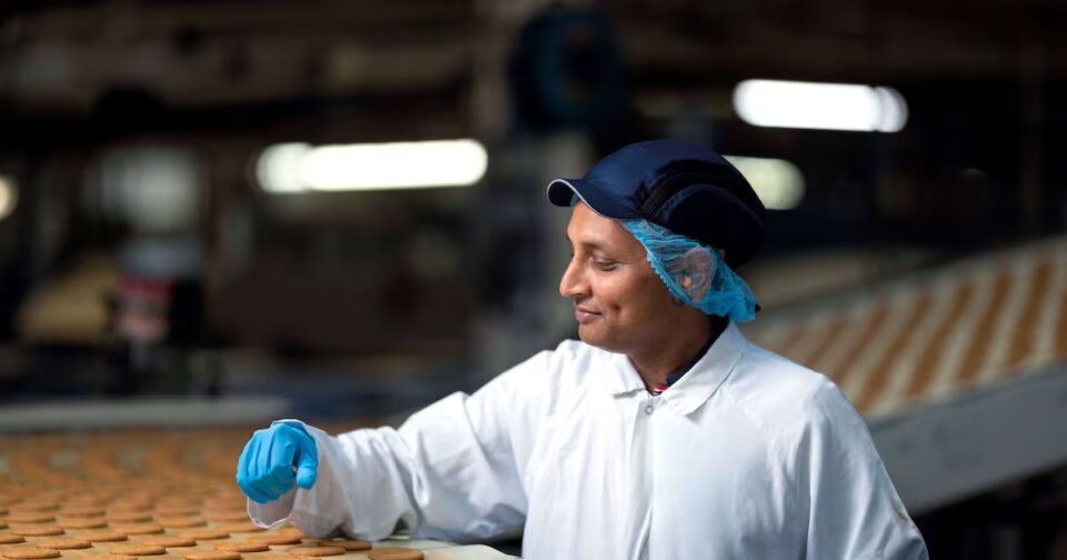 McVitie’s Owner Pladis Reports Mixed Results for 2025 assembly line, baked, biscuit, biscuit factory, close up, color image, conveyor belt, cookie, copy space, Edinburgh, efficient, factory, Food and Drink, food and drink industry, food processing plant, horizontal, in a row, indoors, industrial plant, medium group of objects, motion, nobody, order, packaging, photography, preparing, repetition, round, Scotland, selective focus, wrapped Food and Beverage Business