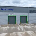 Multivac UK to Open New Innovation Centre in Manchester Next Year assembly line, baked, biscuit, biscuit factory, close up, color image, conveyor belt, cookie, copy space, Edinburgh, efficient, factory, Food and Drink, food and drink industry, food processing plant, horizontal, in a row, indoors, industrial plant, medium group of objects, motion, nobody, order, packaging, photography, preparing, repetition, round, Scotland, selective focus, wrapped Food and Beverage Business